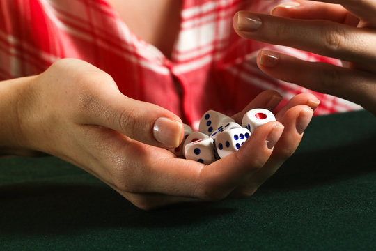Girl holds the dices in her hand
