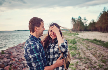 Dating and park. Loving couple sitting together on grass near the lake.