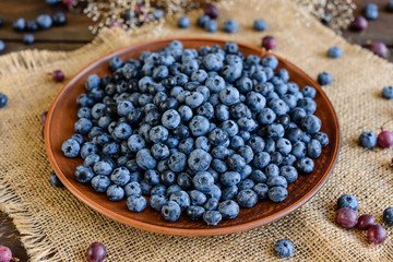Fresh berries of blueberry on a plate. It can be used as a background