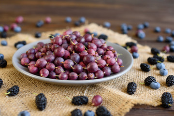 Fresh gooseberry on a plate. It can be used as a background