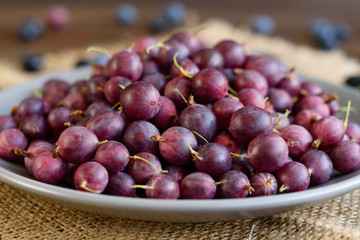 Fresh gooseberry on a plate. It can be used as a background