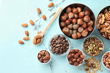 Bowls with different nuts on table