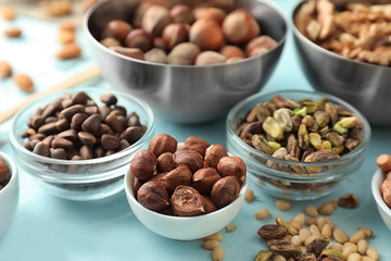 Bowls with different nuts on table