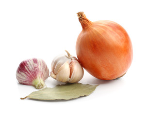 Onion and garlic with bay leaf on white background