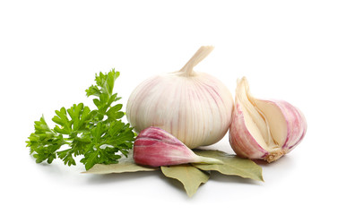 Garlic with parsley and bay leaves on white background