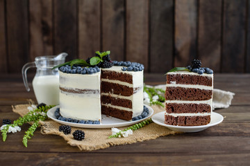 Beautiful tasty cake with white cream and berries of blueberry
