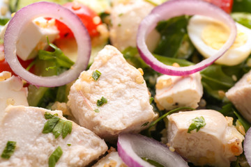 Tasty salad with chicken, vegetables and herbs, closeup