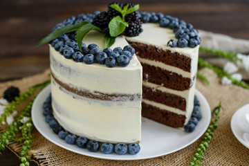 Beautiful tasty cake with white cream and berries of blueberry