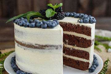 Beautiful tasty cake with white cream and berries of blueberry