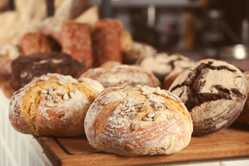 Assortment of fresh bread on counter in bakery