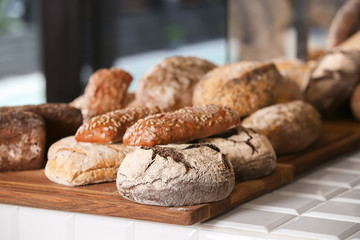 Assortment of fresh bread on counter in bakery