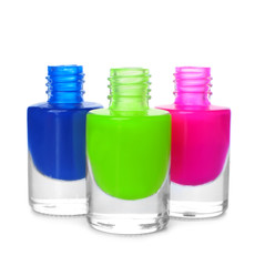 Bottles of colorful nail polishes on white background