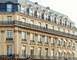 Fototapeta na wymiar Paris residential buildings. Old Paris architecture, beautiful facade, typical french houses on sunny day. Famous travel destinations in Europe. City life, lifestyle and expensive real estate concept