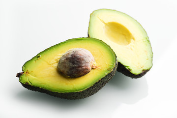 Close view of avocado halves isolated on white background
