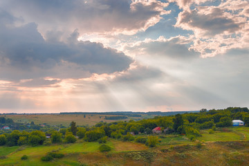 Naklejka na ściany i meble Panorama of a beautiful countryside summer landscape at sunset