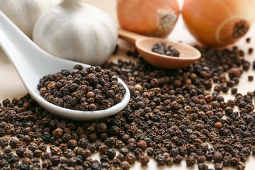 Dry peas pepper with garlic and onion on table, closeup