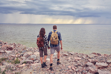 Obraz na płótnie Canvas Couple tourists with backpacks outdoors.