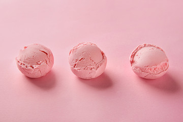 Strawberry ice cream balls on color background