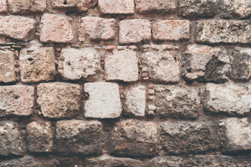 Old stone wall, old texture of natural color authentic stones blocks closeup.Background of stone wall texture. Closeup photo