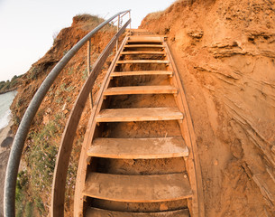 ladder wooden uphill cliff red soil