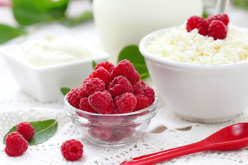 Fresh raspberry in a bowl and dairy product for breakfast