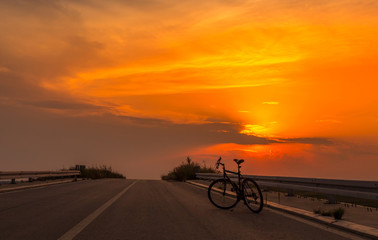 Fototapeta na wymiar Silhouette Bike At Sunset 1