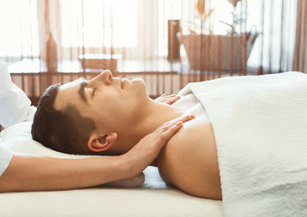 Man getting massage in spa centre