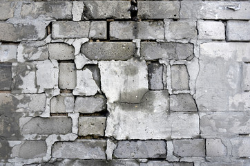 Chipped grey brick wall