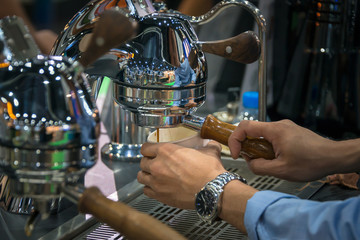 Coffee Espresso with temper in coffee machine pouring fresh a coffee