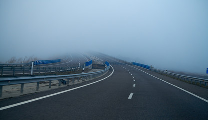 Fototapeta premium Foggy road with fog in horizon