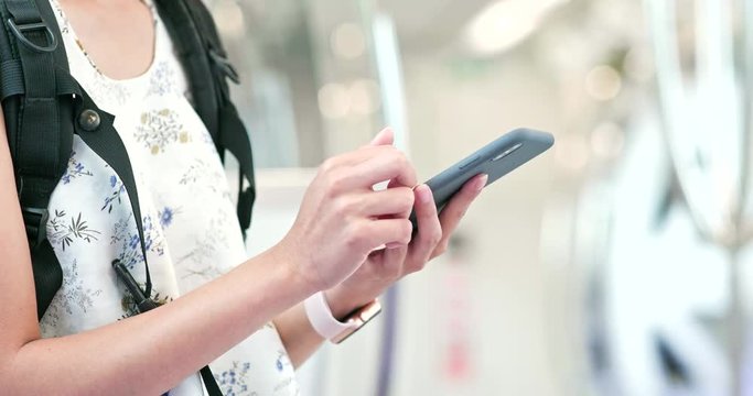 Close up of woman using cellphone on train