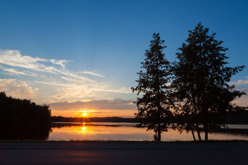 Fototapeta na wymiar Sunset at lakeside serene summer evening