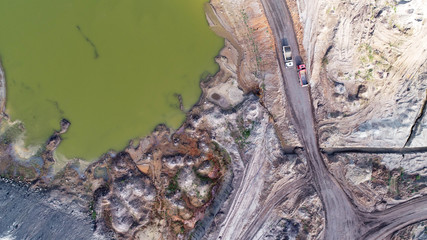 Aerial view on open pit mine of sand, hummus and coal, flooded with water