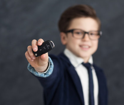 Cute little boy showing new car's keys