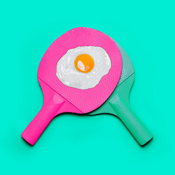 Ping pong and egg on a turquoise background. Fashion minimal art.