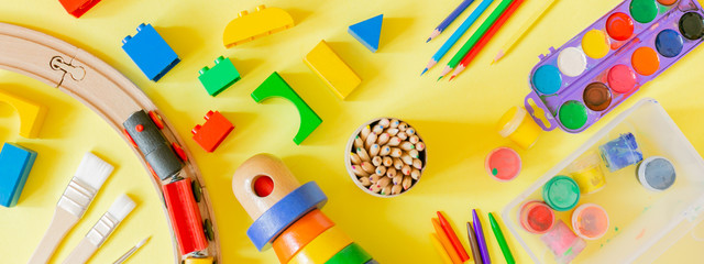 Day care concept - art supplies and toys on bright background - obrazy, fototapety, plakaty