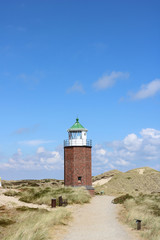 Fototapeta na wymiar Landscape of Rotes Kliff lighthouse, on the island of Sylt, Germany, located on a cliffside north of the village of Kampen.