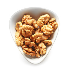 Bowl with tasty walnuts on white background