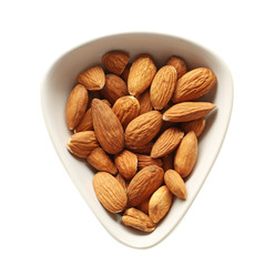 Bowl with tasty almonds on white background