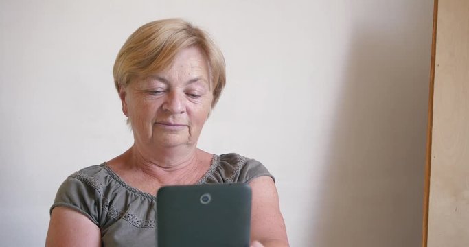 an elderly woman with a tablet