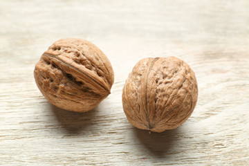 Unpeeled walnuts on wooden background