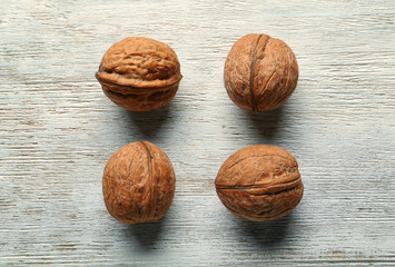 Unpeeled walnuts on wooden background