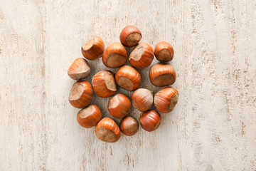 Unpeeled hazelnuts on wooden background