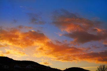 Sunset mountain silhouette with orange clouds