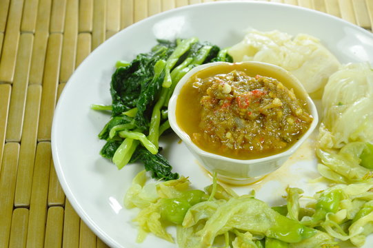 horseshoe crab chili paste eat couple with variety boiled vegetable on plate