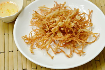 fried crispy needle mushroom on plate dipping sweet sauce