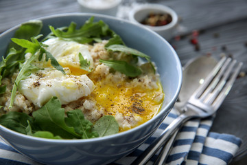 Bowl with delicious oatmeal, herbs and egg on table, closeup