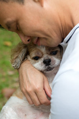 Asian young man with his pet Shih Tzu puppy dog outdoor © Kenishirotie