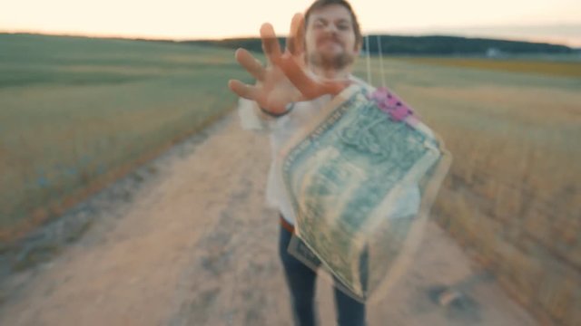 A man chases after a dollar that flies in the wind. the concept of the desire for profit and income