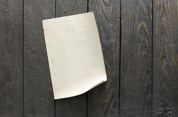 old paper on dark wooden wall